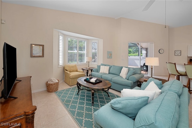 tiled living room featuring ceiling fan