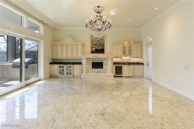 unfurnished living room featuring beverage cooler, sink, crown molding, and an inviting chandelier