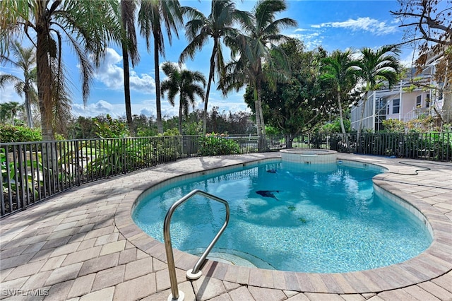 view of swimming pool featuring a patio and an in ground hot tub