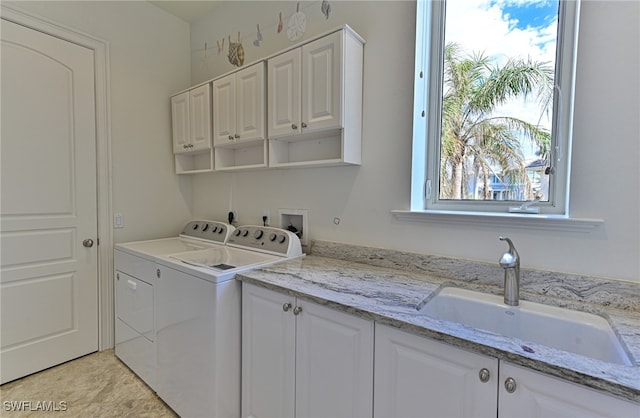 laundry room with cabinets, sink, and independent washer and dryer