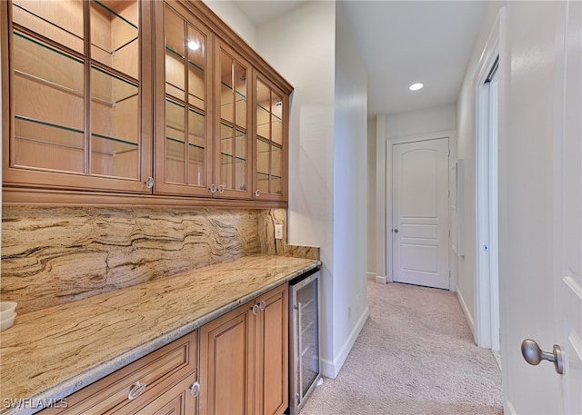 bar featuring wine cooler, light carpet, decorative backsplash, and light stone counters