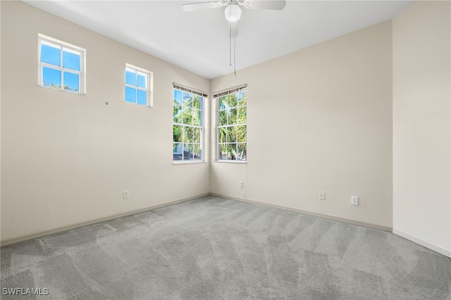 unfurnished room featuring ceiling fan and light carpet