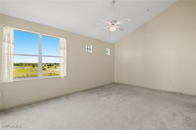 unfurnished room featuring lofted ceiling, ceiling fan, and light colored carpet