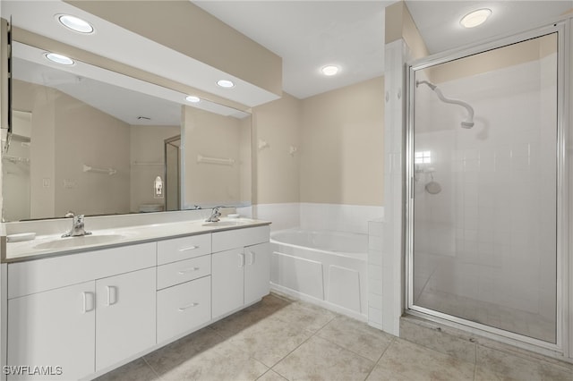 bathroom featuring shower with separate bathtub, tile patterned floors, and vanity