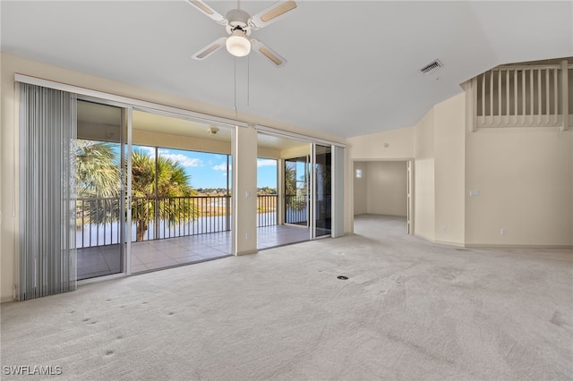 unfurnished room with lofted ceiling, light carpet, and ceiling fan