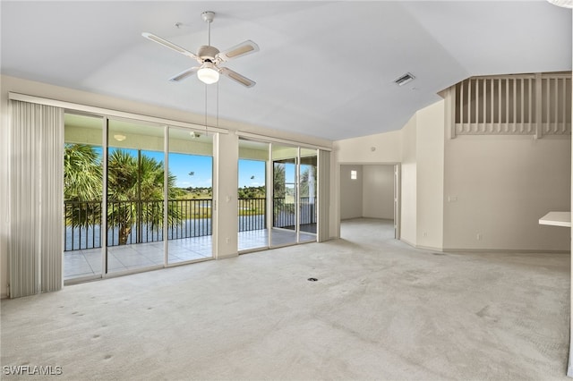 unfurnished living room with ceiling fan, carpet floors, and lofted ceiling