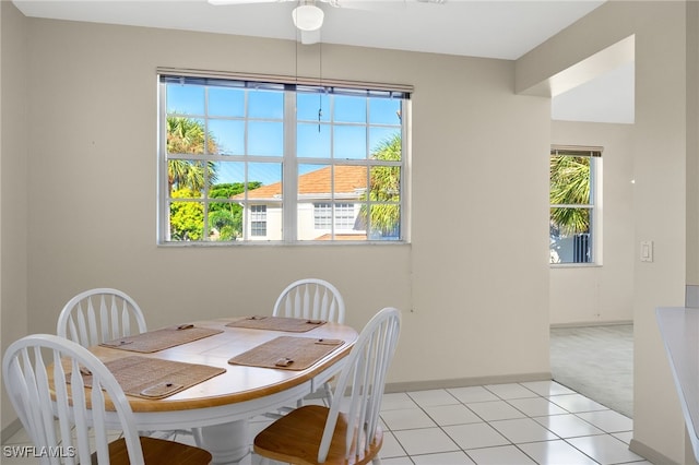 dining room featuring ceiling fan and light colored carpet