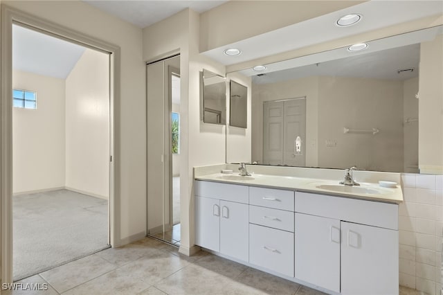 bathroom with tile patterned flooring and vanity