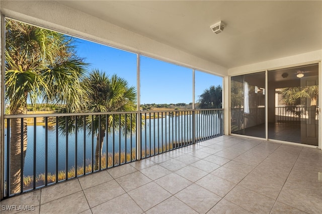 unfurnished sunroom featuring a water view