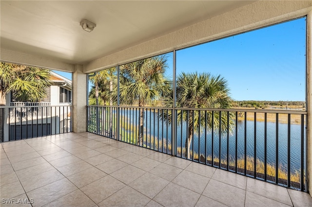 unfurnished sunroom with a water view