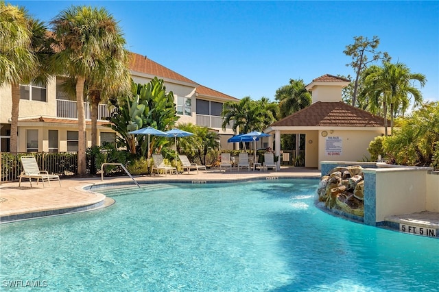 view of pool with a patio area and pool water feature