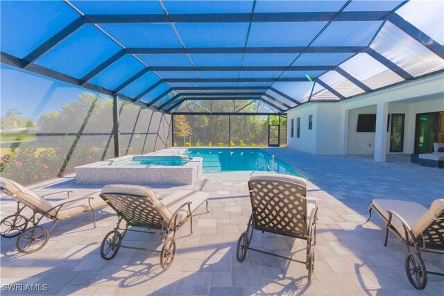 view of pool featuring a lanai, a patio, and an in ground hot tub