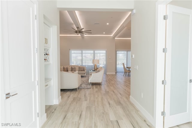 living room with ceiling fan and light hardwood / wood-style flooring