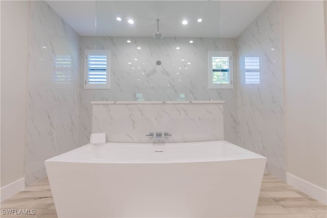 bathroom with plus walk in shower and hardwood / wood-style floors