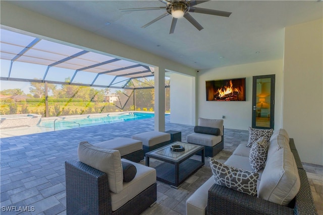 view of patio / terrace featuring an outdoor hangout area, glass enclosure, and ceiling fan