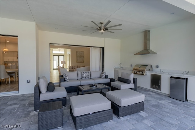 living room with ceiling fan with notable chandelier, hardwood / wood-style flooring, and sink