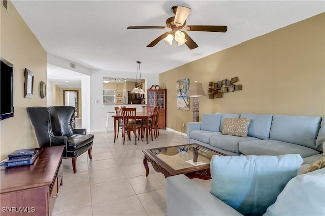 living room featuring ceiling fan and light tile patterned floors