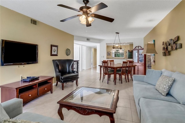 living room with ceiling fan and light tile patterned floors