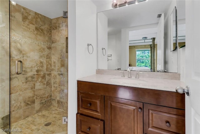 bathroom featuring vanity and an enclosed shower