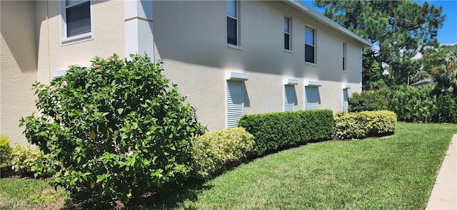 view of side of home featuring a lawn