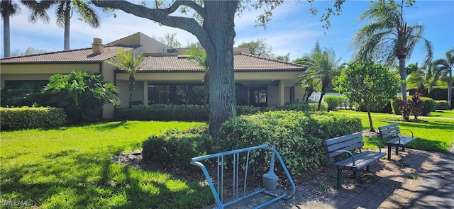 rear view of house featuring a patio area and a yard