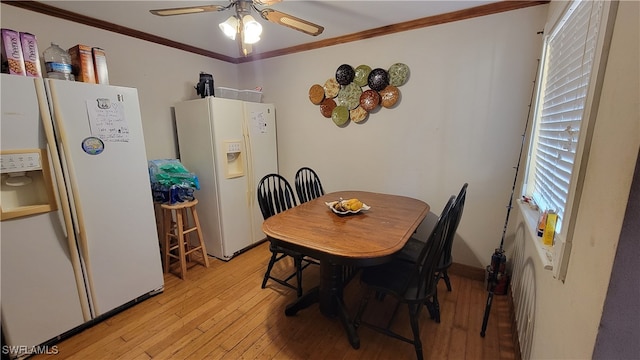 dining room with ornamental molding, light wood-type flooring, and ceiling fan