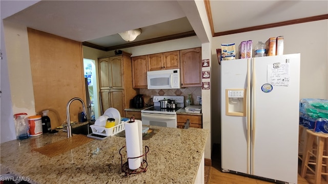 kitchen featuring light hardwood / wood-style floors, white appliances, light stone counters, decorative backsplash, and ornamental molding