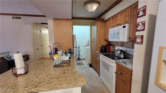 kitchen featuring light stone counters, tasteful backsplash, white appliances, kitchen peninsula, and ornamental molding