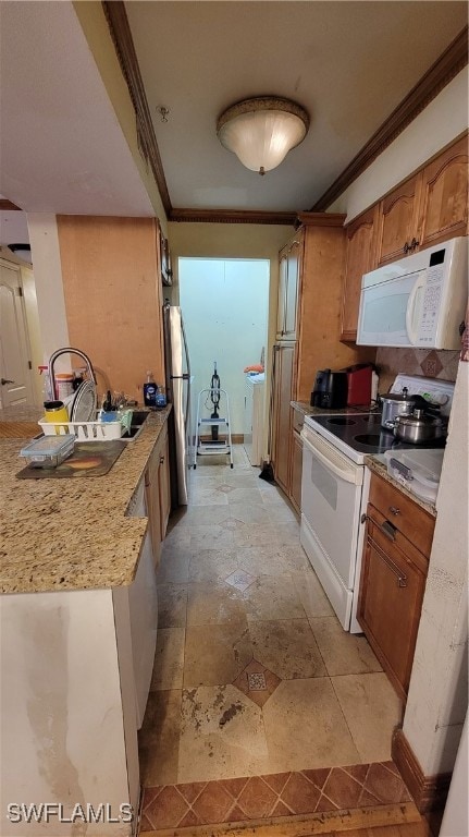 kitchen featuring white appliances and crown molding