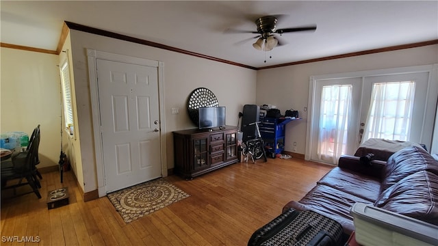 living room featuring ceiling fan, ornamental molding, french doors, and hardwood / wood-style floors