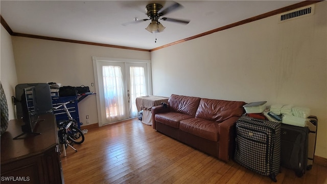 living room with ornamental molding, ceiling fan, and hardwood / wood-style floors