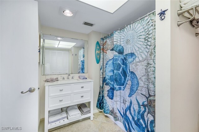 bathroom featuring a shower with curtain, vanity, and tile patterned floors