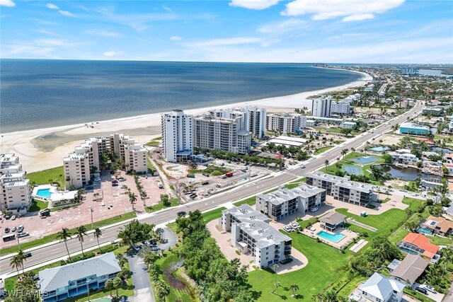 birds eye view of property featuring a water view and a beach view