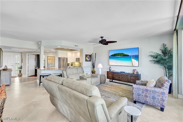 living room with ceiling fan and light tile patterned floors