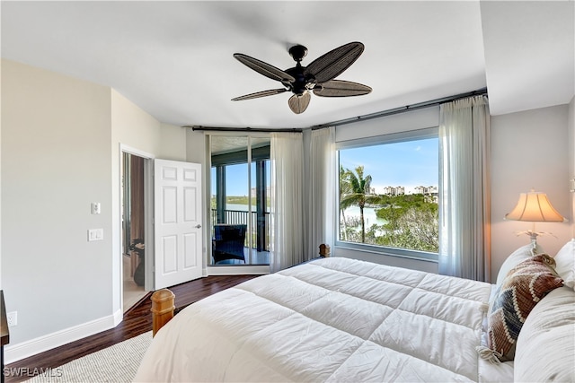 bedroom with multiple windows, dark hardwood / wood-style floors, ceiling fan, and access to exterior