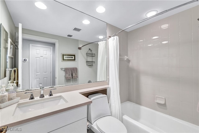 full bathroom with vanity, toilet, and shower / bath combo with shower curtain