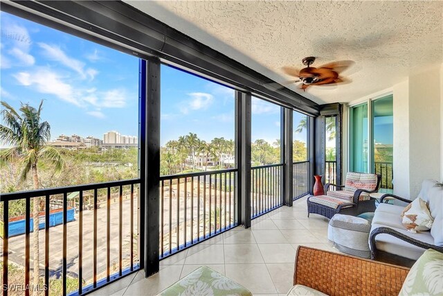 sunroom / solarium featuring ceiling fan