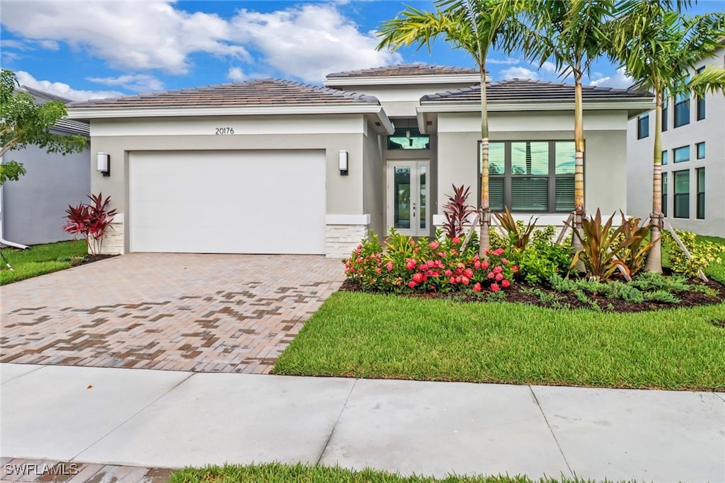 view of front of house with a front lawn and a garage