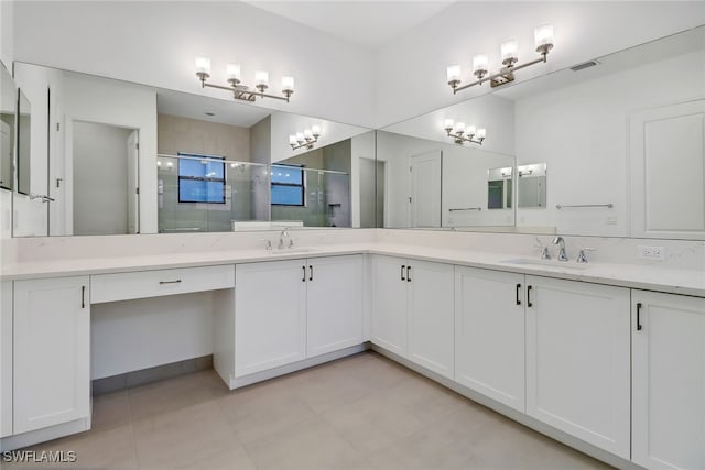 bathroom with a shower with door and vanity