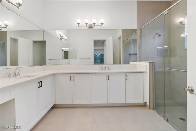 bathroom with tile patterned flooring, vanity, and a shower with shower door