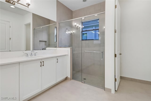 bathroom featuring walk in shower and vanity