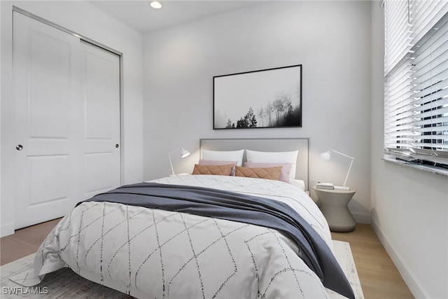 bedroom featuring hardwood / wood-style flooring and a closet