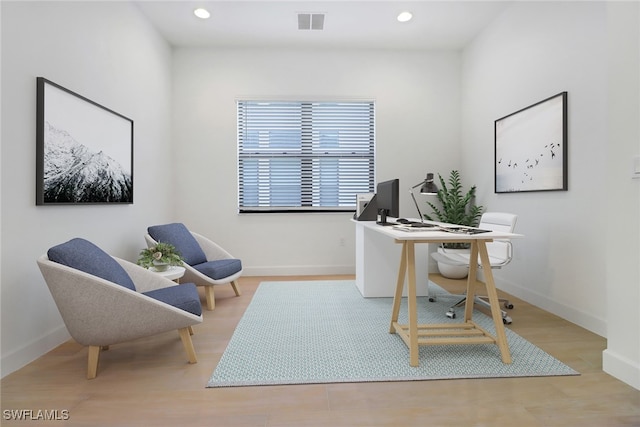 office with light hardwood / wood-style floors