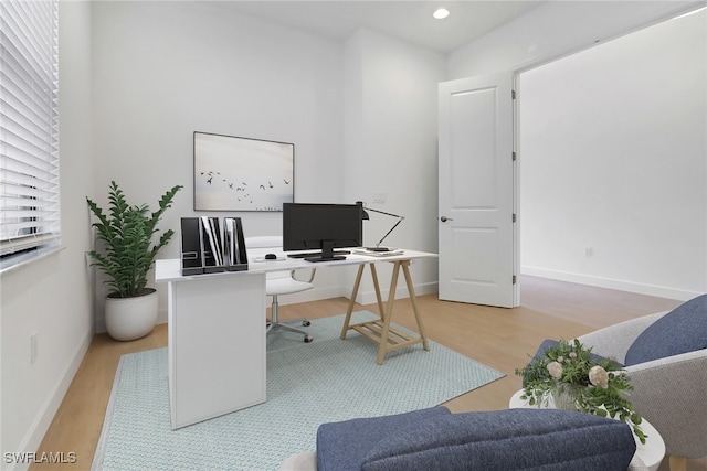 home office with wood-type flooring