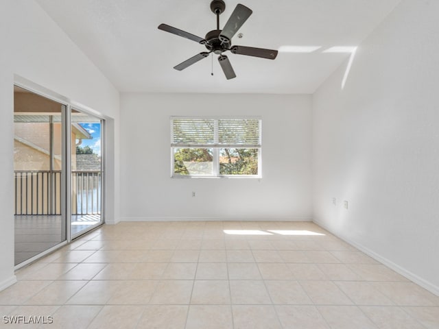 tiled spare room with ceiling fan