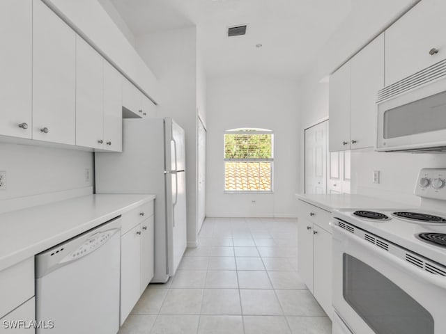 kitchen featuring white cabinets, white appliances, and light tile patterned flooring