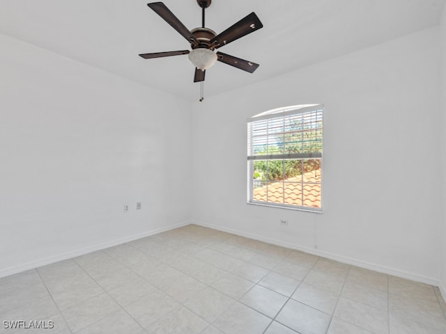 tiled empty room featuring ceiling fan