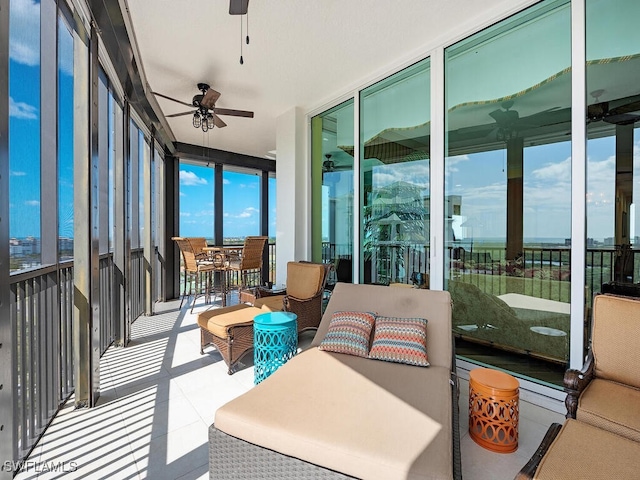 sunroom featuring ceiling fan