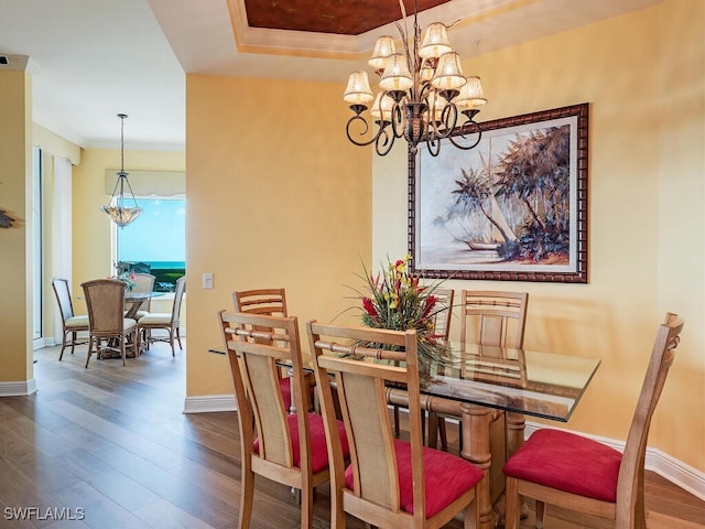 dining room with a chandelier, crown molding, and wood-type flooring