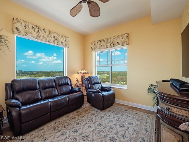 living room featuring ceiling fan and light hardwood / wood-style floors